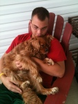 Adam Erdely snuggles on the patio with a dog